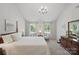 Bright and airy main bedroom with neutral decor, large windows, and comfortable seating area at 505 Southland Rd, Huntersville, NC 28078