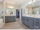 Bright bathroom featuring dual sinks, vanity, walk-in closet, and glass enclosed shower at 5078 Hyannis Ct, Matthews, NC 28104
