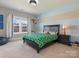 Cozy bedroom with a striped accent wall, window, and sports-themed decor at 5078 Hyannis Ct, Matthews, NC 28104