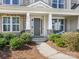 Inviting front porch with stone pillars and seating, perfect for enjoying the outdoors at 5078 Hyannis Ct, Matthews, NC 28104