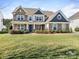 Charming two-story home featuring stone accents and a well-manicured front yard at 5078 Hyannis Ct, Matthews, NC 28104