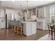 Bright kitchen with stainless steel appliances, an island with seating, and plenty of cabinet space at 5078 Hyannis Ct, Matthews, NC 28104
