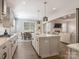 Modern kitchen with a spacious island, stainless steel appliances, and a breakfast nook at 5078 Hyannis Ct, Matthews, NC 28104