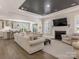 Spacious living room with a fireplace, dark ceiling accent, neutral furniture, and hardwood flooring at 5078 Hyannis Ct, Matthews, NC 28104