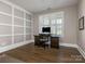 Bright home office with custom wall trim, shutters, and a well-lit work area at 5078 Hyannis Ct, Matthews, NC 28104