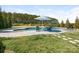 Relaxing backyard pool area with comfortable seating and a lush green lawn at 5078 Hyannis Ct, Matthews, NC 28104