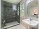 Updated bathroom featuring a glass shower with subway tile and a vessel sink with sleek fixtures at 517 Wingrave Dr, Charlotte, NC 28270