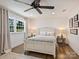 Cozy bedroom featuring a large window with a treed view, and hardwood floors at 517 Wingrave Dr, Charlotte, NC 28270