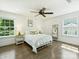Inviting bedroom featuring two windows with a nice outside view and hardwood floors at 517 Wingrave Dr, Charlotte, NC 28270