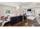 Combined bedroom and seating area with hardwood floors, lots of sunlight, and entertainment center at 517 Wingrave Dr, Charlotte, NC 28270