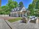 A detached garage with a brick driveway and an outdoor living space with an upper deck at 517 Wingrave Dr, Charlotte, NC 28270