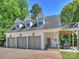 Detached three-car garage with charming curb appeal, complemented by a cozy outdoor sitting area at 517 Wingrave Dr, Charlotte, NC 28270