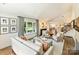 Spacious living room boasts hardwood floors, neutral colors, and plenty of natural light at 517 Wingrave Dr, Charlotte, NC 28270