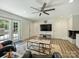 Spacious living room featuring French doors, a modern fireplace and a ceiling fan at 517 Wingrave Dr, Charlotte, NC 28270