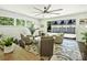 Bright living area featuring a large ceiling fan and sliding doors that open to a garage at 517 Wingrave Dr, Charlotte, NC 28270