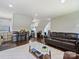 Open concept living area with cozy leather seating, dining table and computer and kitchen area at 517 Wingrave Dr, Charlotte, NC 28270