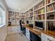 Spacious home office with extensive custom built-in bookshelves, perfect for a productive workspace at 517 Wingrave Dr, Charlotte, NC 28270