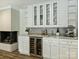 Stylish wet bar with a built-in wine cooler, granite countertops and a modern fireplace at 517 Wingrave Dr, Charlotte, NC 28270