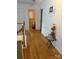Bright hallway features hardwood floors leading to a bathroom, plus a charming wall decoration at 5228 Sunriver Rd, Gastonia, NC 28054