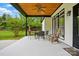 Inviting back porch with ceiling fan, comfortable seating, and view of the lush backyard at 530 Dovefield Dr, Indian Trail, NC 28079