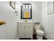 Charming half-bathroom features a vanity with storage and a classic toilet at 530 Dovefield Dr, Indian Trail, NC 28079