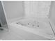 Bright bathroom showcasing a large white jacuzzi tub under shuttered windows at 530 Dovefield Dr, Indian Trail, NC 28079
