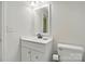 Bright bathroom featuring modern sink with a mirror, new fixtures, and toilet at 530 Dovefield Dr, Indian Trail, NC 28079