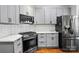 Well-equipped kitchen with stainless steel appliances, gray cabinets, and quartz countertops at 530 Dovefield Dr, Indian Trail, NC 28079
