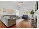 Open concept living room featuring neutral colored furniture, fireplace, and hardwood floors at 530 Dovefield Dr, Indian Trail, NC 28079