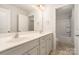 Well-lit bathroom featuring a double sink vanity, framed mirror, and separate shower at 5684 Garrow Glen Rd # 96, Charlotte, NC 28278