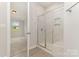 Modern bathroom with a glass enclosed shower, and tile surround at 5684 Garrow Glen Rd # 96, Charlotte, NC 28278
