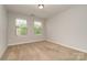 Bedroom featuring neutral walls, plush carpeting, and natural light from double windows at 5684 Garrow Glen Rd # 96, Charlotte, NC 28278