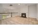 Large bonus room with neutral carpet, fireplace, and open view to the floor below at 5684 Garrow Glen Rd # 96, Charlotte, NC 28278