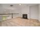 Large bonus room with neutral carpet, fireplace, and open view to the floor below at 5684 Garrow Glen Rd # 96, Charlotte, NC 28278