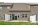 Back exterior featuring a sliding glass door and a small concrete patio at 5684 Garrow Glen Rd # 96, Charlotte, NC 28278