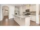 Bright kitchen with stainless steel appliances, granite counters, and a kitchen island at 5684 Garrow Glen Rd # 96, Charlotte, NC 28278
