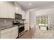 Modern kitchen with stainless steel appliances, granite counters, and an open view to the backyard at 5684 Garrow Glen Rd # 96, Charlotte, NC 28278