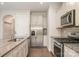 Well-equipped kitchen featuring stainless steel appliances, granite counters, and white cabinets at 5684 Garrow Glen Rd # 96, Charlotte, NC 28278