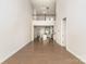 Open-concept living space with hardwood floors, a lofted landing and connecting kitchen at 5684 Garrow Glen Rd # 96, Charlotte, NC 28278