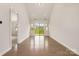 Bright living room featuring hardwood floors, neutral walls and sliding door to a green lawn at 5684 Garrow Glen Rd # 96, Charlotte, NC 28278
