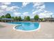 Community pool featuring a large swimming area, lounge chairs, and shade structures at 5684 Garrow Glen Rd # 96, Charlotte, NC 28278