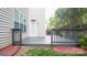 A relaxing gray wood back deck is surrounded by lush green foliage at 5808 Mcdowell Run Dr, Huntersville, NC 28078