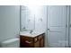 Cozy bathroom featuring a toilet, vanity, mirror, and towel holder at 5808 Mcdowell Run Dr, Huntersville, NC 28078
