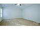 Bright bedroom with beige carpeting and a ceiling fan, ready for personalization at 5808 Mcdowell Run Dr, Huntersville, NC 28078
