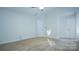 Spacious bedroom with neutral carpeting, ceiling fan, and two doors at 5808 Mcdowell Run Dr, Huntersville, NC 28078