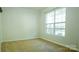 Neutral carpeted bedroom featuring a large window allowing for natural light at 5808 Mcdowell Run Dr, Huntersville, NC 28078