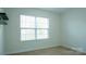 Inviting carpeted bedroom with a large window offering natural light at 5808 Mcdowell Run Dr, Huntersville, NC 28078