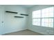 Well-lit bedroom showcasing window and contemporary floating shelves at 5808 Mcdowell Run Dr, Huntersville, NC 28078