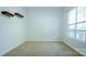 A bright bedroom with plush carpeting, neutral walls and trim and a large window at 5808 Mcdowell Run Dr, Huntersville, NC 28078