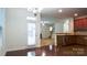 Open-concept dining area with hardwood floors, connecting to the kitchen and living spaces at 5808 Mcdowell Run Dr, Huntersville, NC 28078